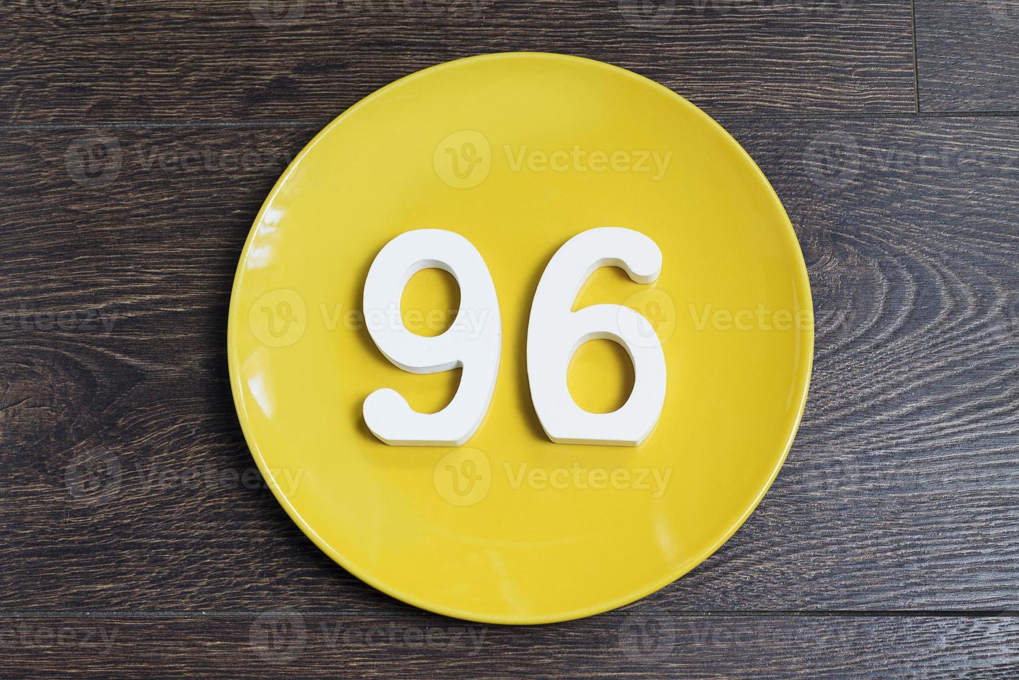 The number ninety-six on a yellow plate. photo