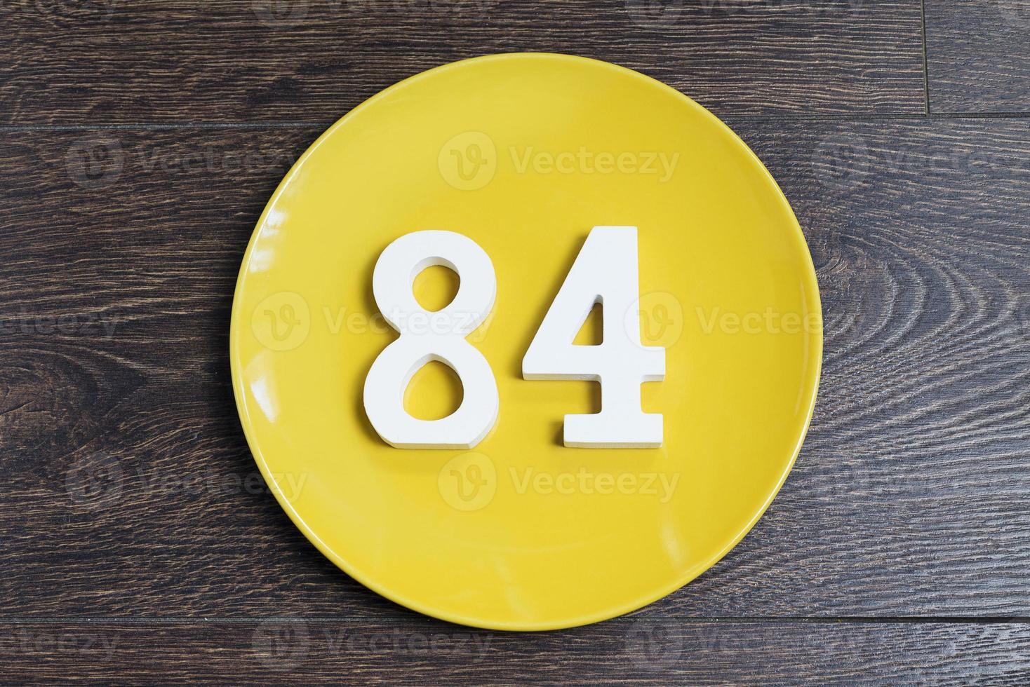 The number eighty-four on the yellow plate. photo