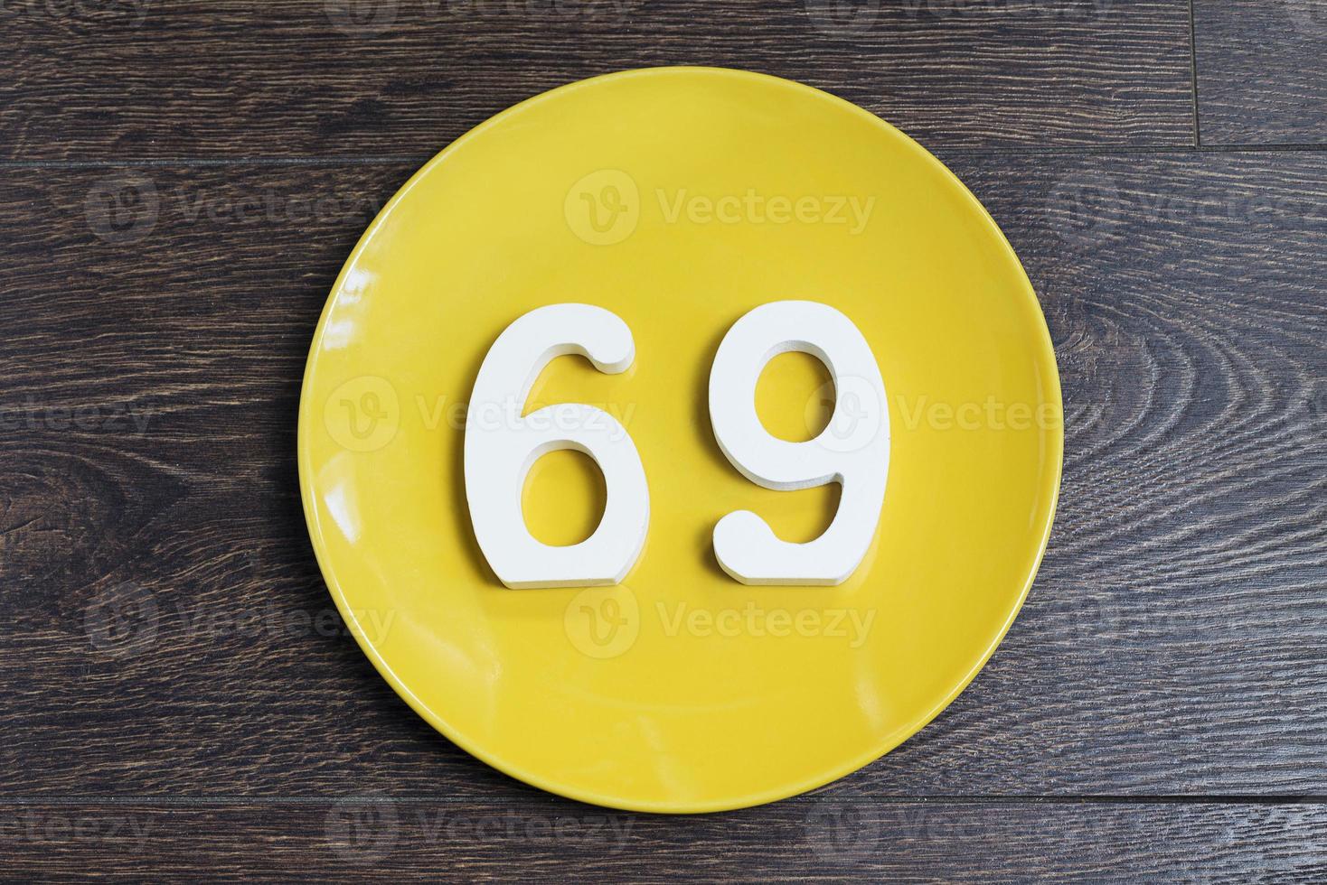 The number sixty-nine on the yellow plate. photo