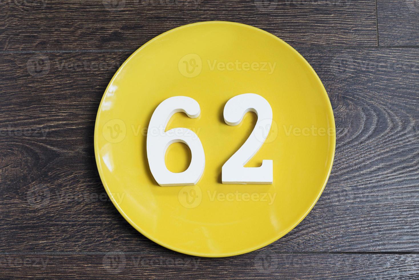 The number sixty-two on the yellow plate. photo