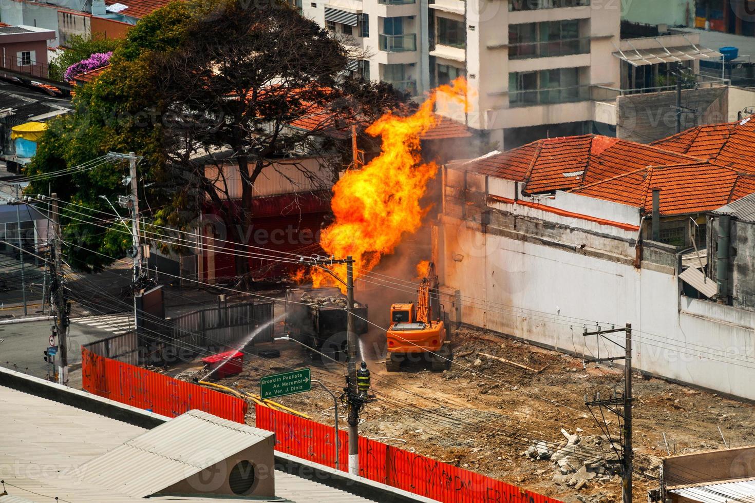 Firefighters fighting a fire caused by a gas leak in a street of Sao Paulo. The city famous for its cultural and business vocation in Brazil. photo