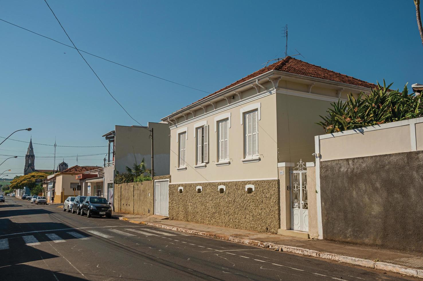 Sao Manuel, Brazil, October 14, 2017. Working-class old house with wall in an empty street on a sunny day at Sao Manuel. A cute little town in the countryside of Sao Paulo State. photo