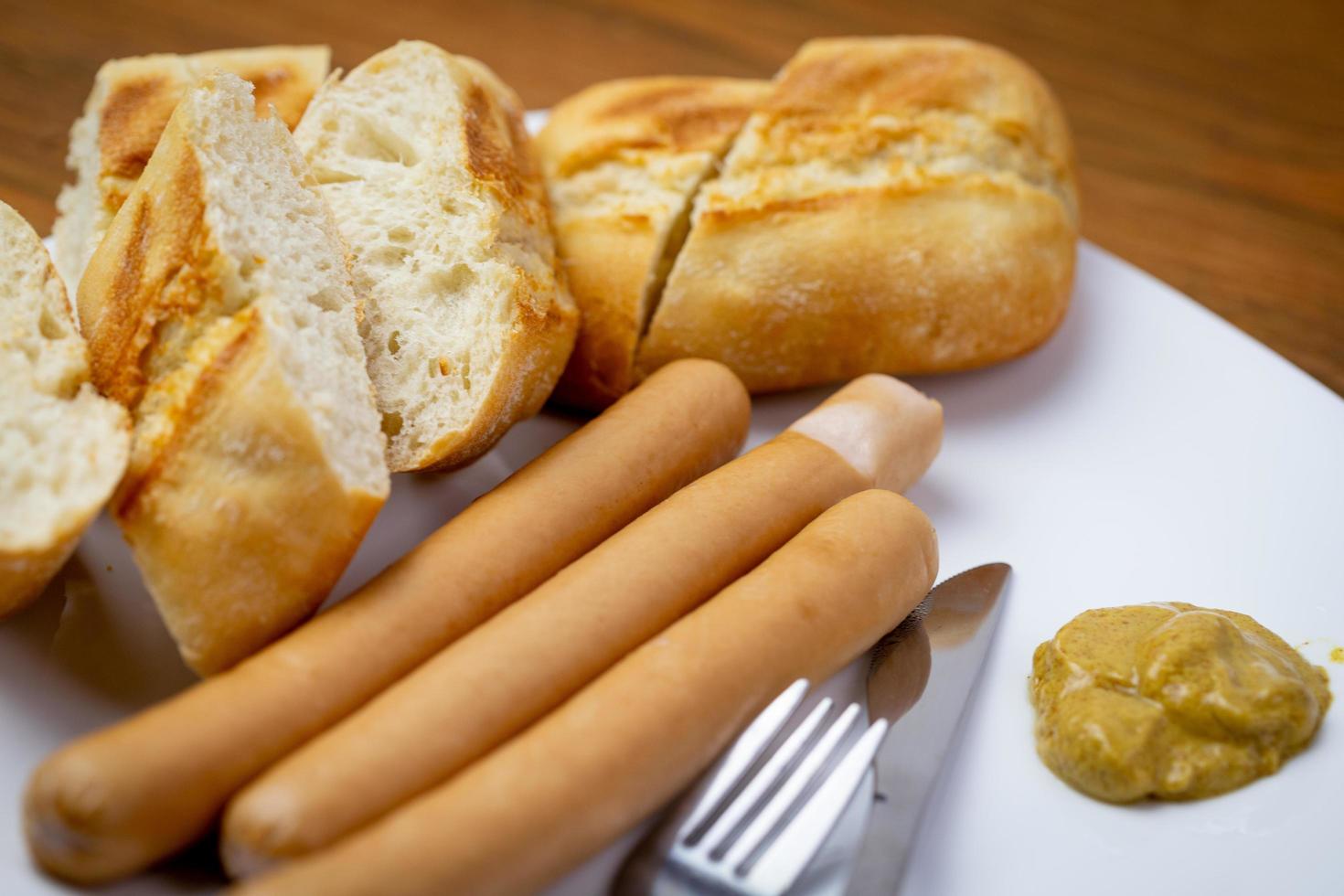 Sausages with a crispy roll. Delicious breakfast. photo
