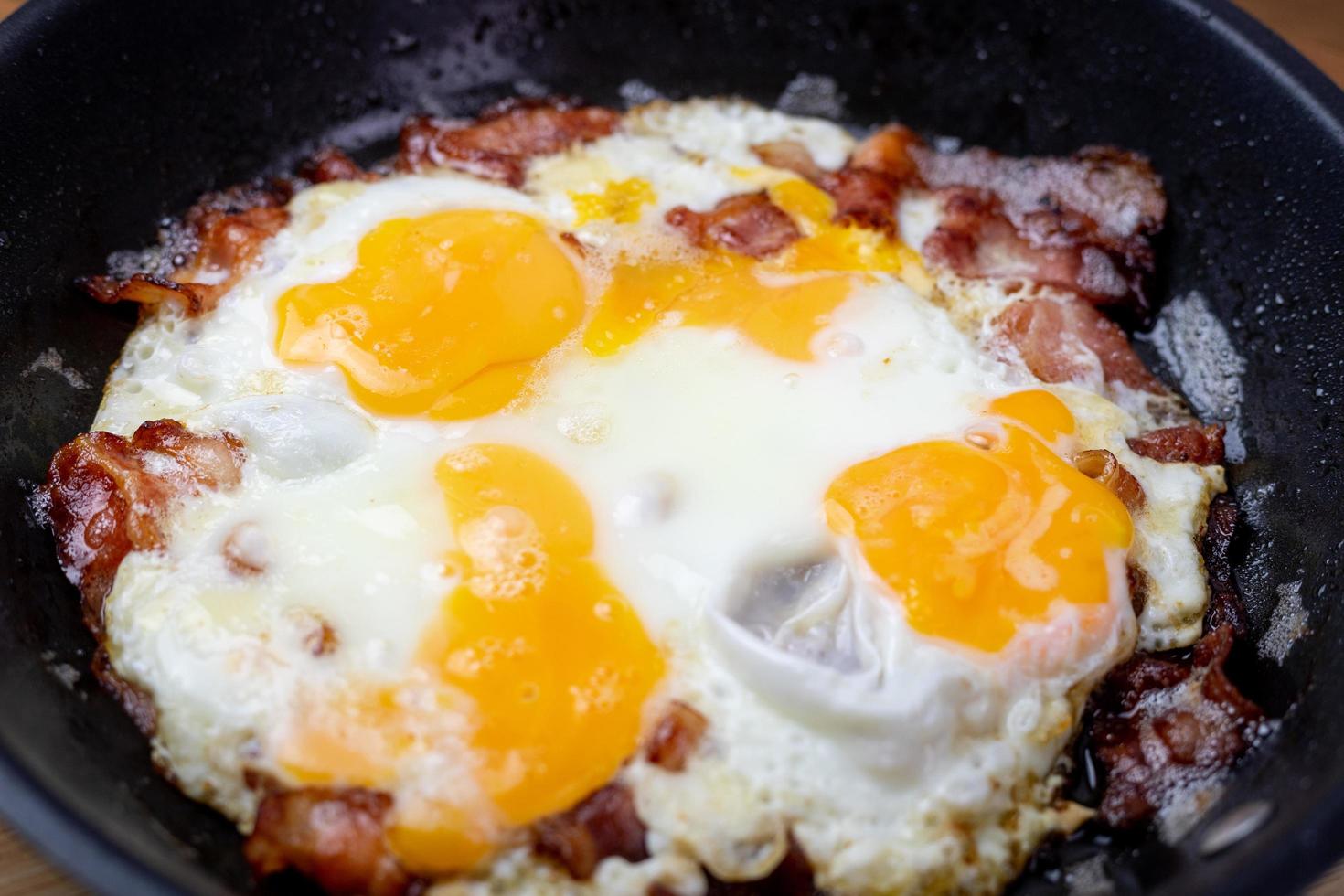 Fried egg with bacon in a pan. photo