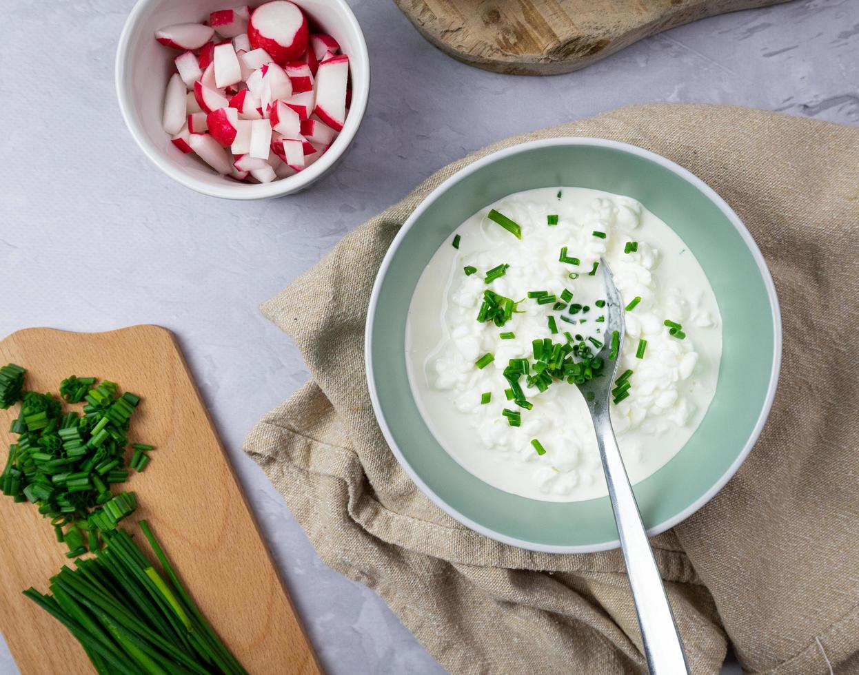 A healthy homemade breakfast. Cottage cheese with chives, radish and bread. photo