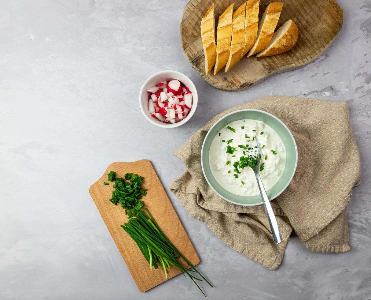 A healthy homemade breakfast. Cottage cheese with chives, radish and bread. photo