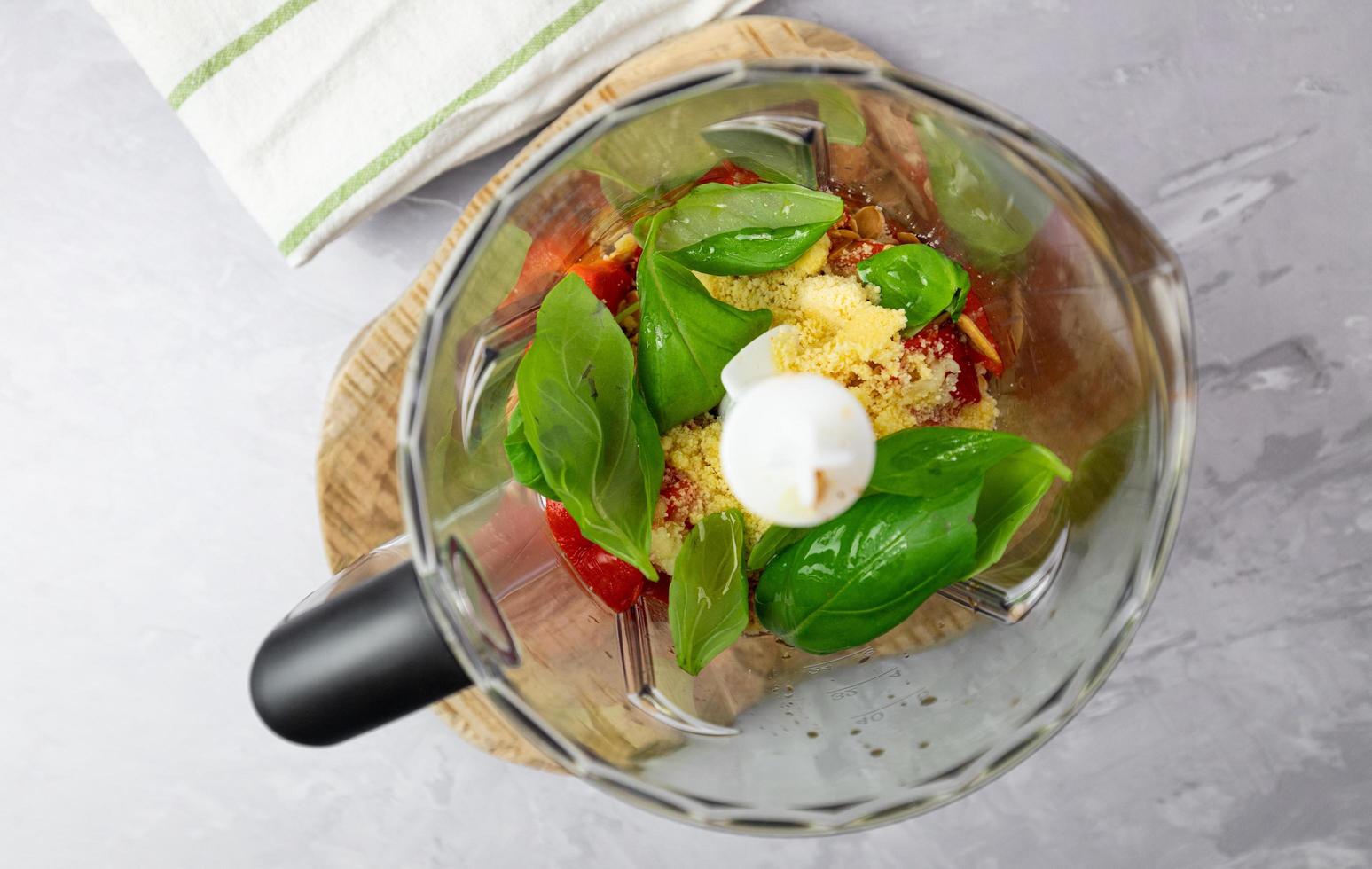 Ingredients for pepper pesto in a blender. Preparation of Italian food. Top view. photo