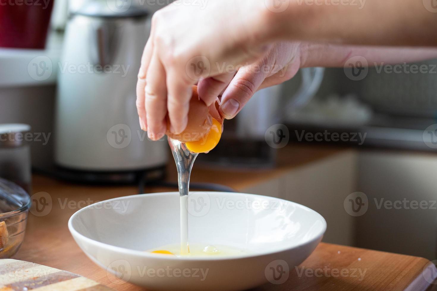 Egg broken into a bowl. Preparation of ingredients for breading. photo