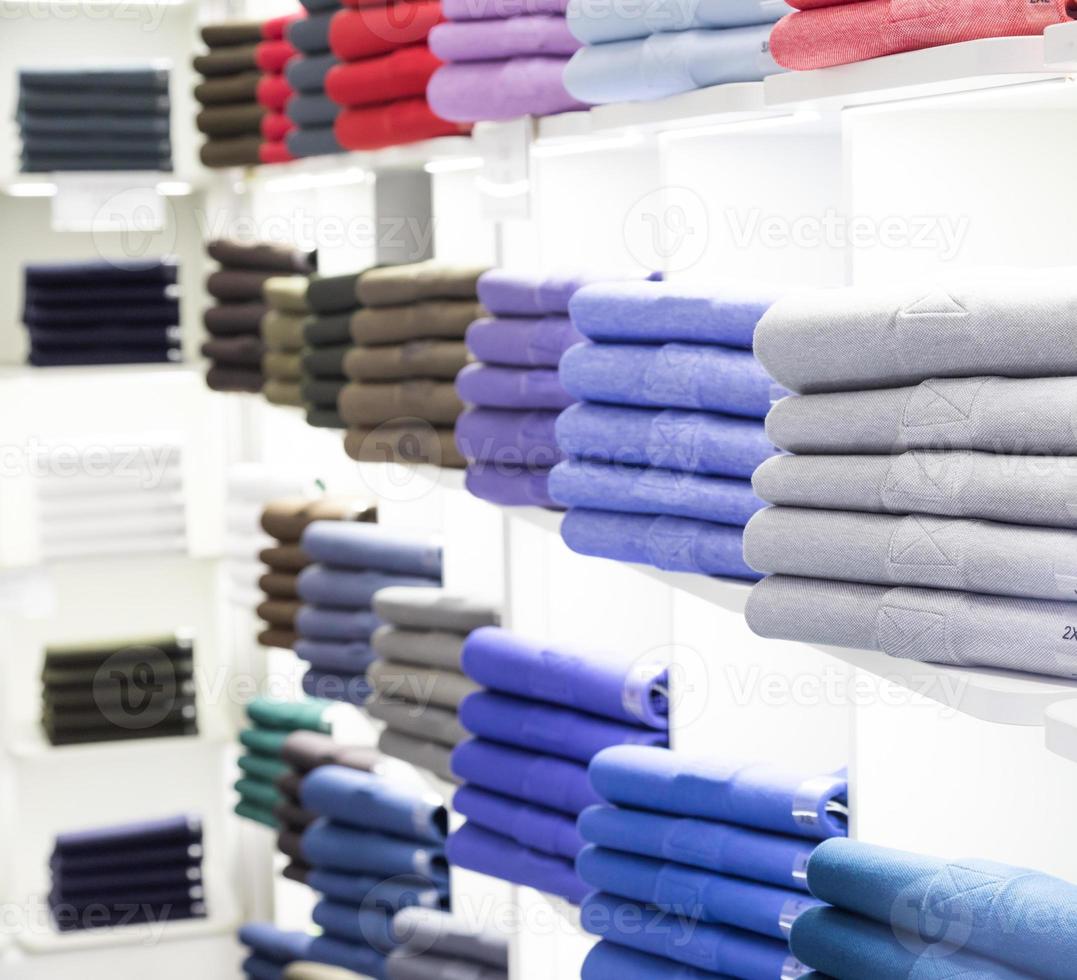 Polo t-shirt store interior. Shop shelves with  colored fashion cotton shirt photo