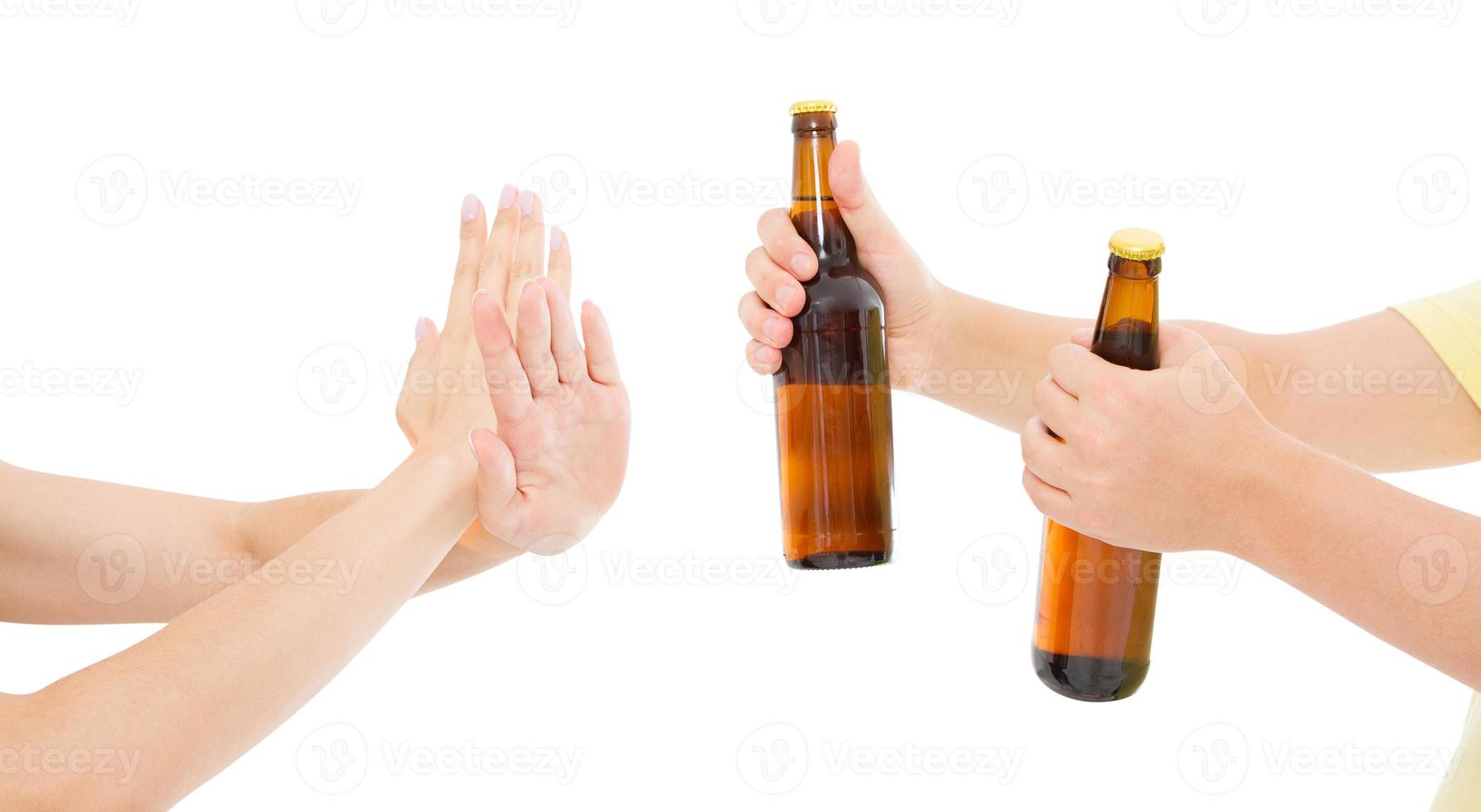 hand reject a bottle of beer isolated on white background, anti alcohol concept. Copy space,mock up,social programs photo