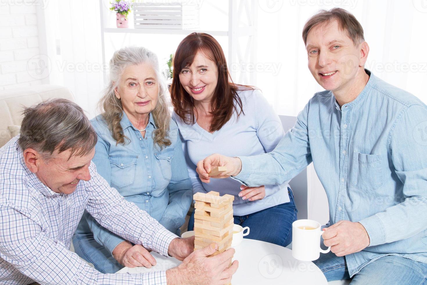 Elderly couple with family Closeup making a pyramid with empty wooden cubes close up photo