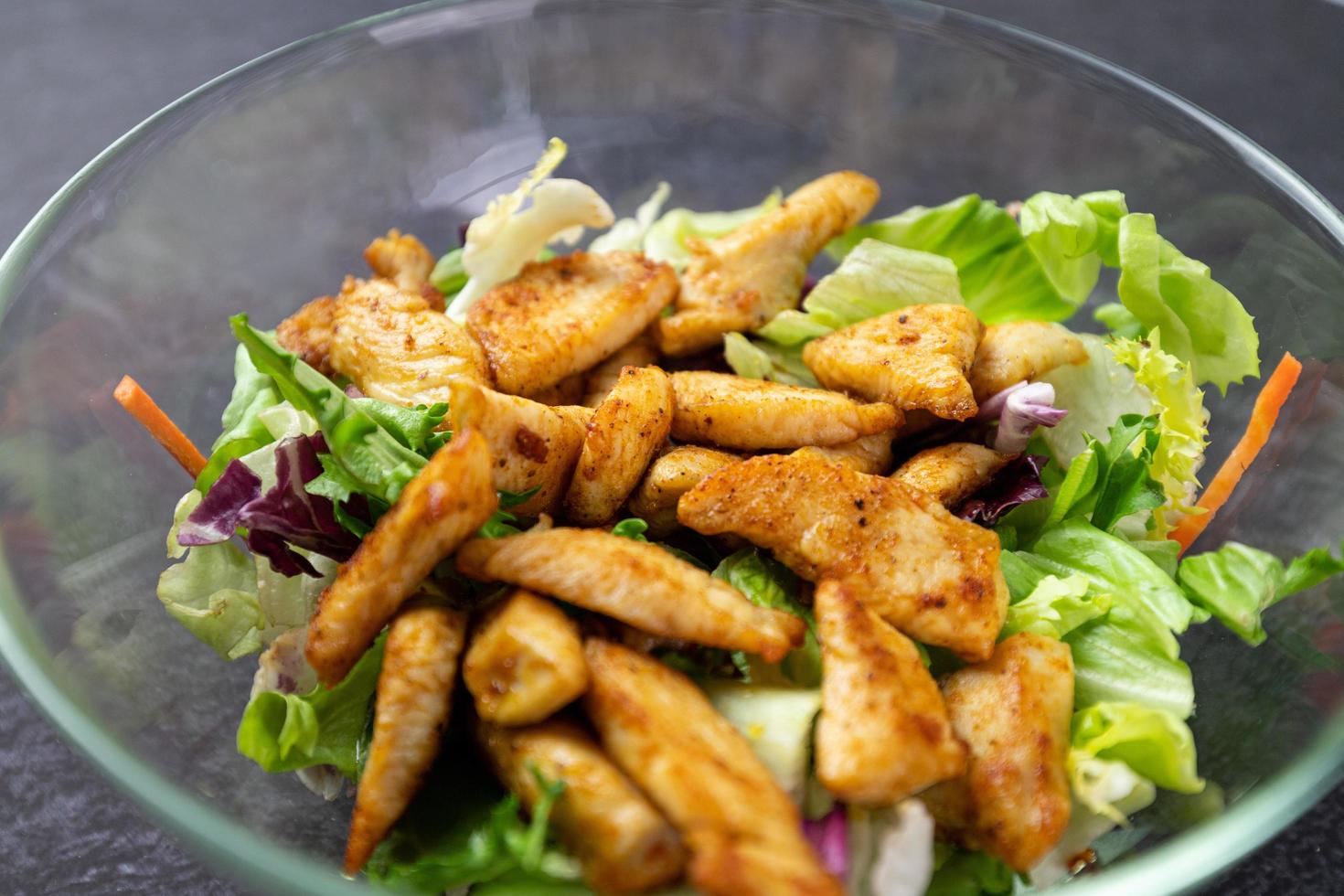 Dietary salad with chicken and lettuce in a glass dish. photo