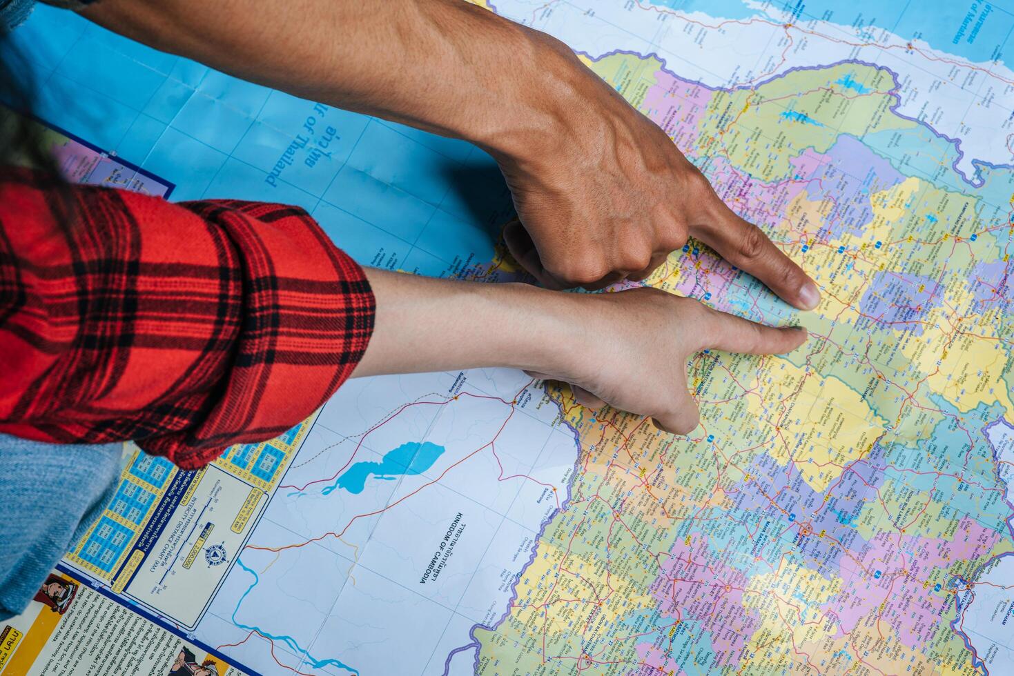 The tourist pointed their finger at the map. photo
