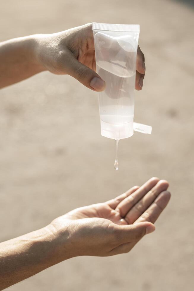 Women wearing white shirts that press the gel to wash hands to clean hands. photo