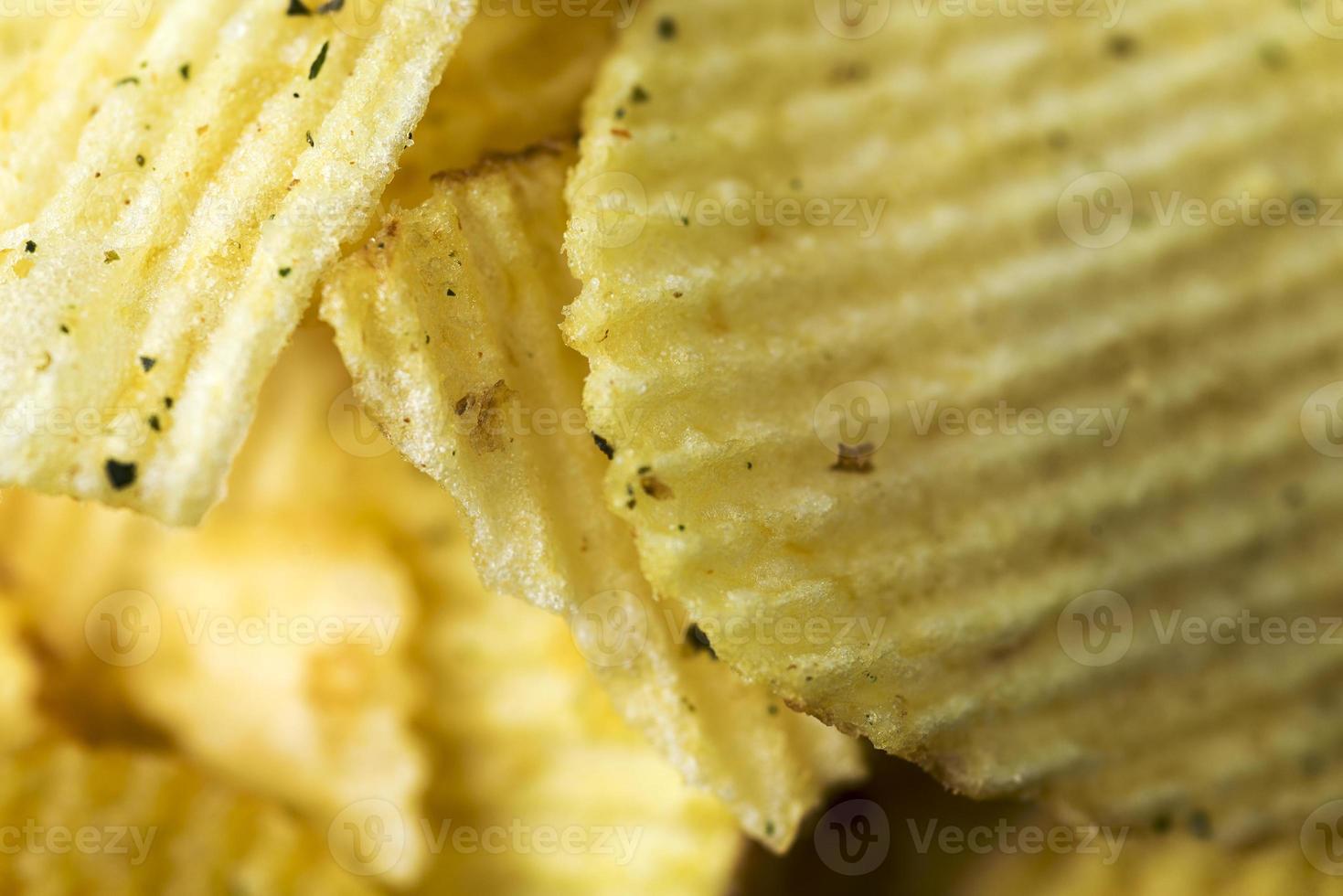 Fried potatoes, fluted chips close-up. photo