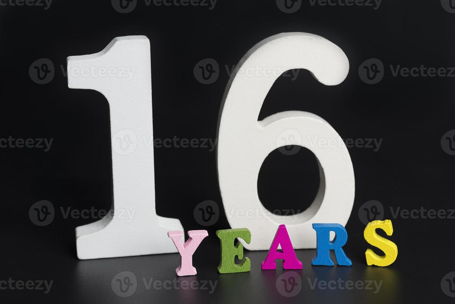 Letters and numbers sixteen on a black background. photo