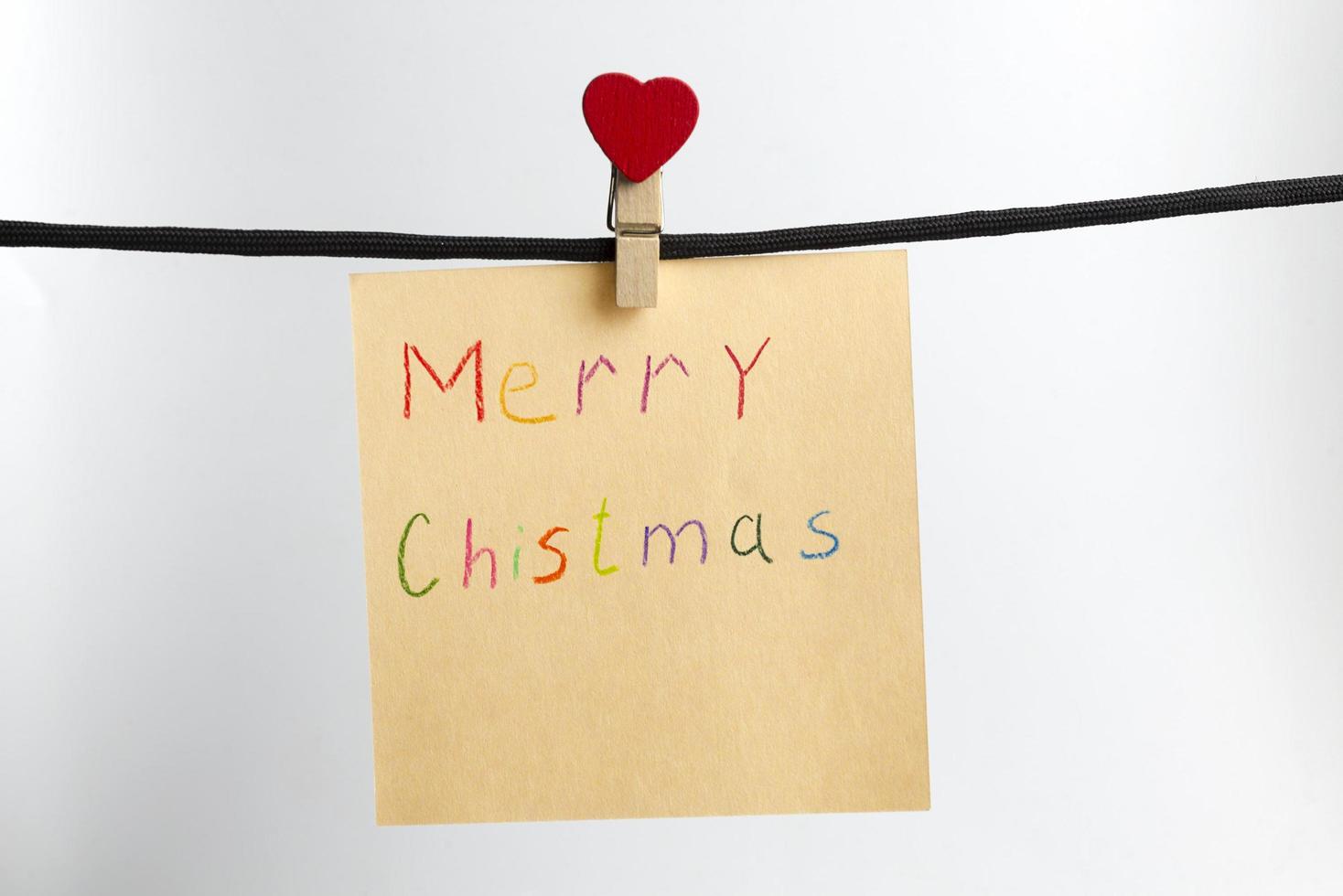 Paper weighs on the black rope with the words merry Christmas. photo