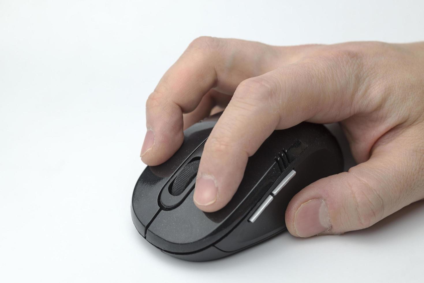 Hand holds a computer mouse. photo