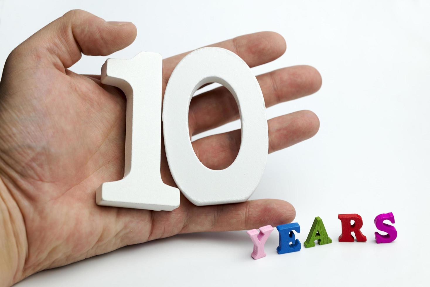 Hand holds a number ten. photo