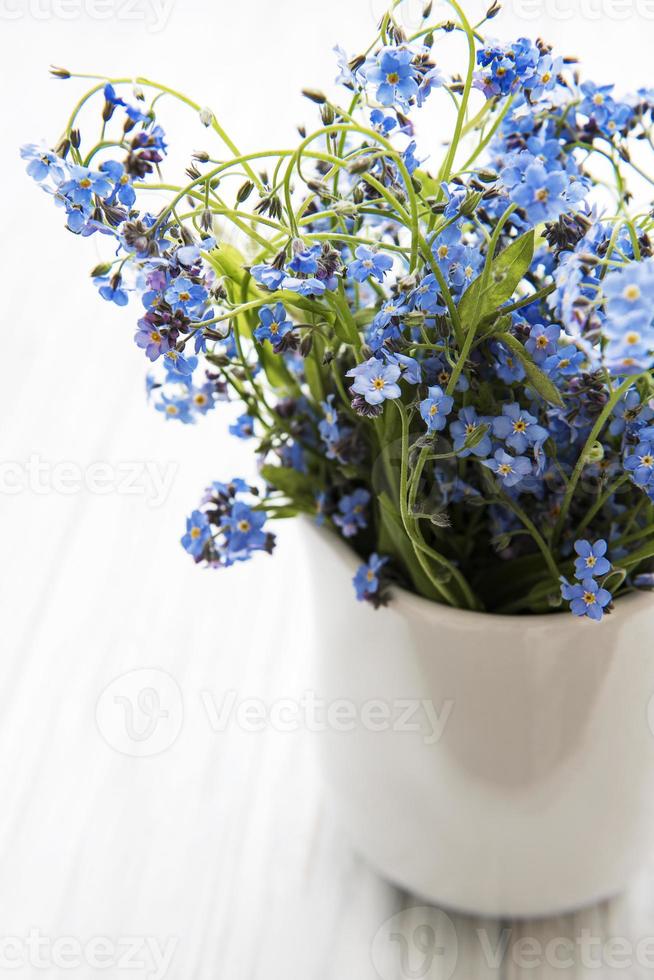 Forget me not flowers in a cup photo