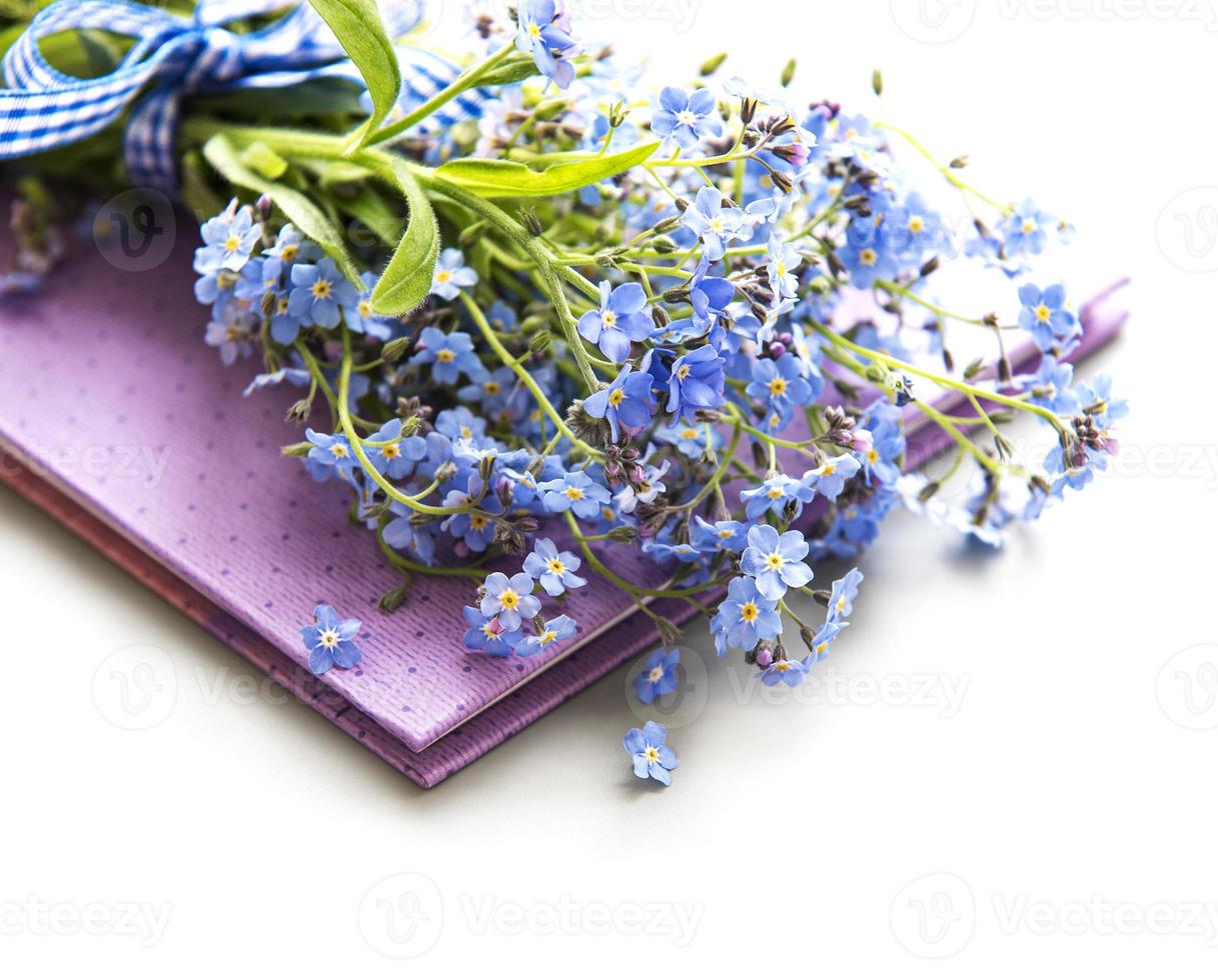 Forget-me-not flowers and notebook photo