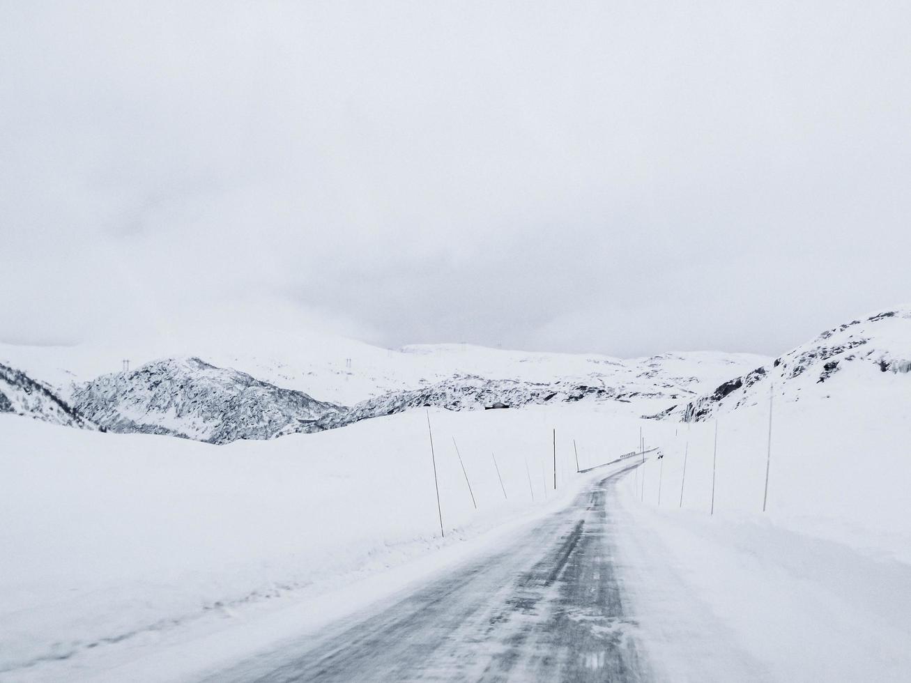 Driving through snowy road and landscape in Norway. photo