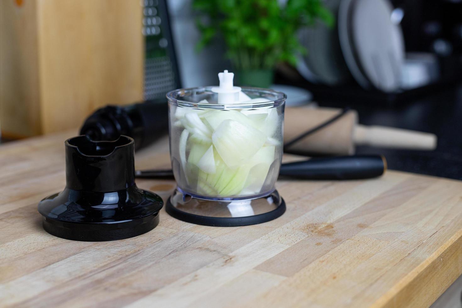 Onion in a blending container. Preparation of ingredients for cooking. photo