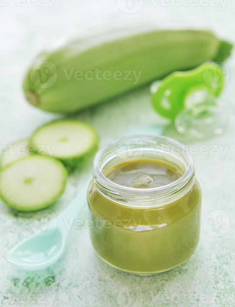 Jar with healthy baby food and zucchini photo