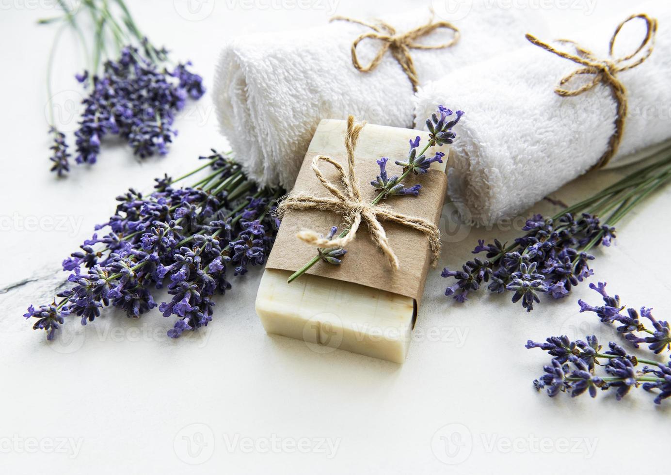 Spa setting with natural soap, towels and lavender photo