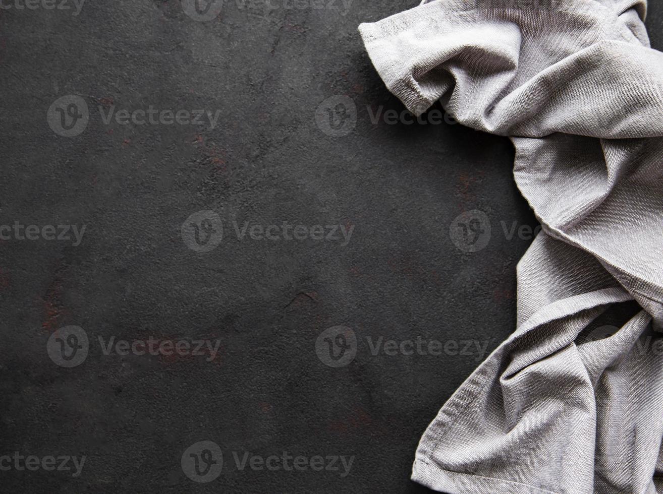 Grey linen tablecloth on a black background countertops. photo