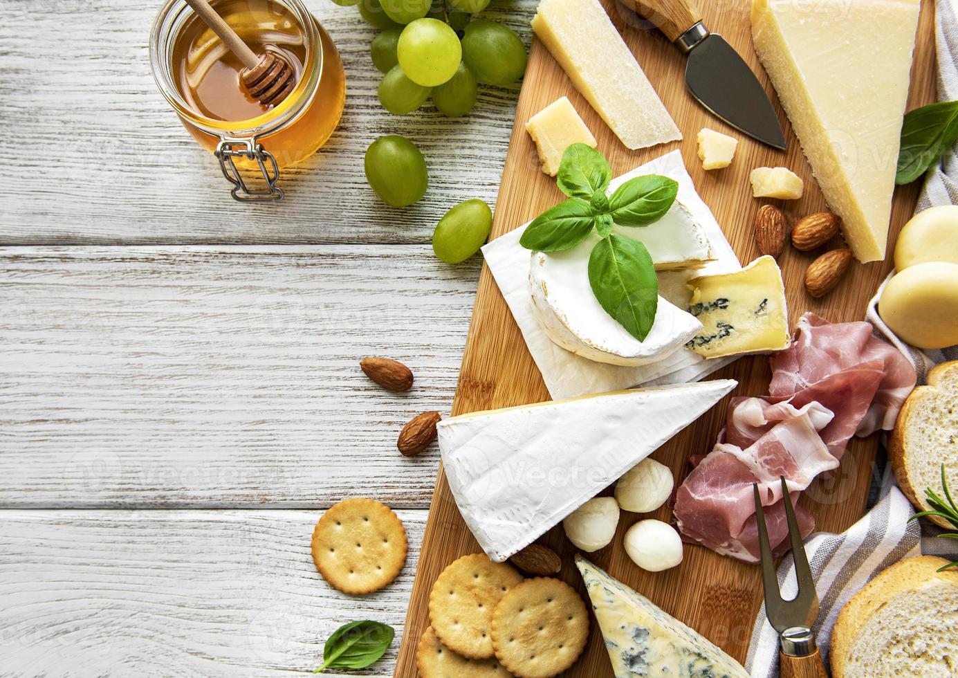 Various types of cheese  on a white wooden  background photo