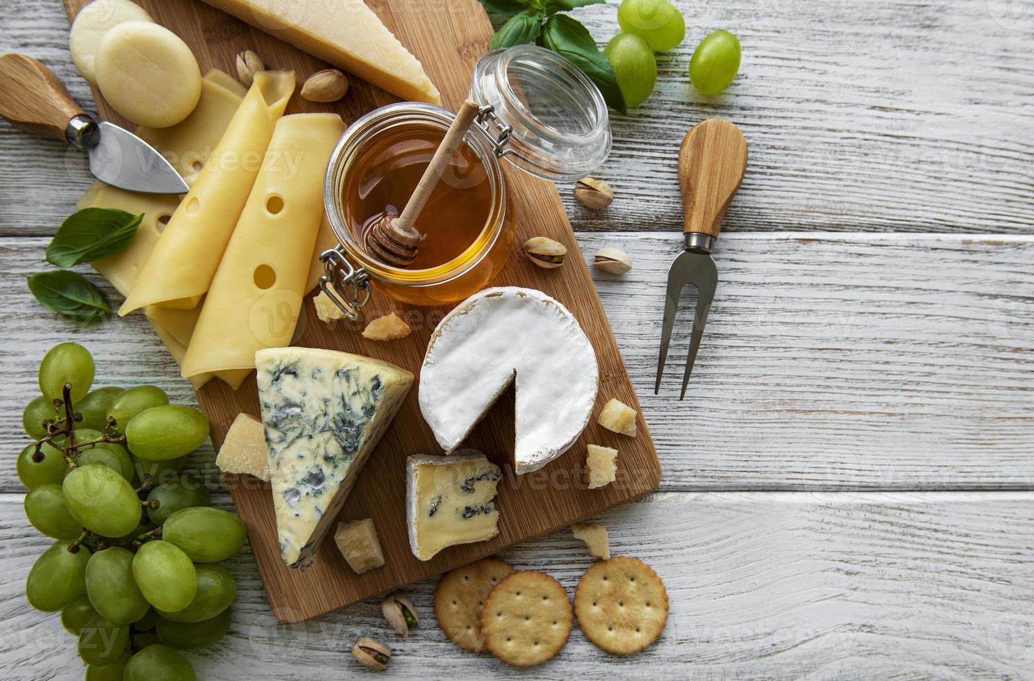 Various types of cheese  on a white wooden  background photo