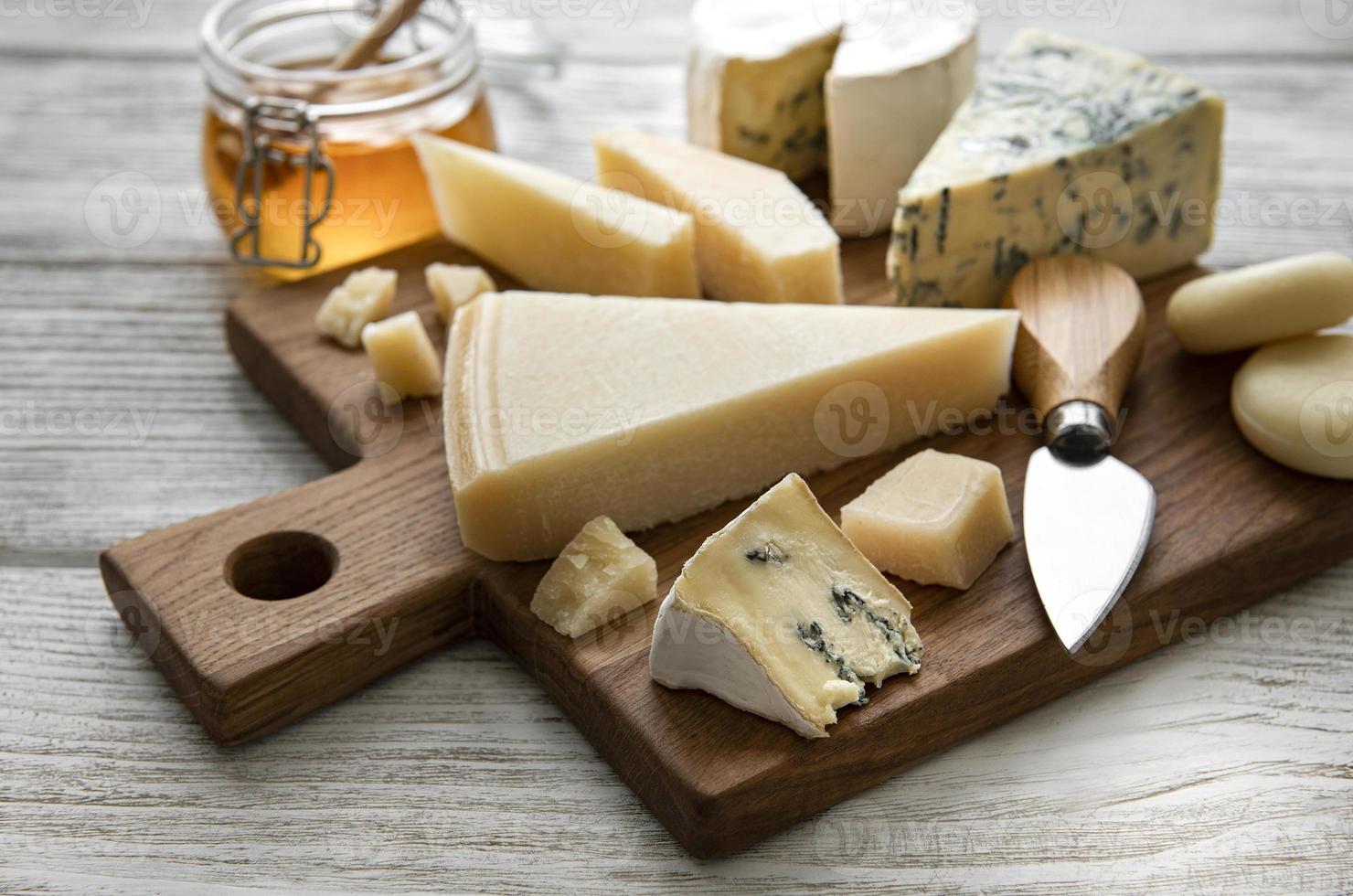 Various types of cheese  on a white wooden  background photo