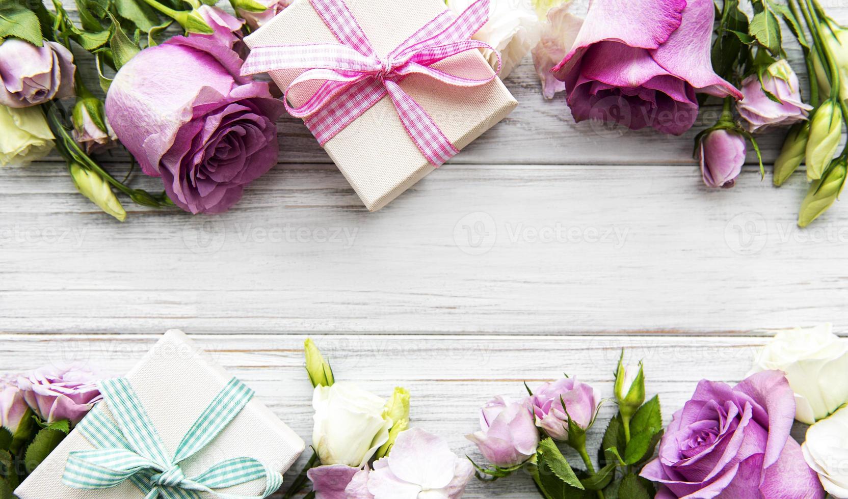 Pink roses and gift boxes photo