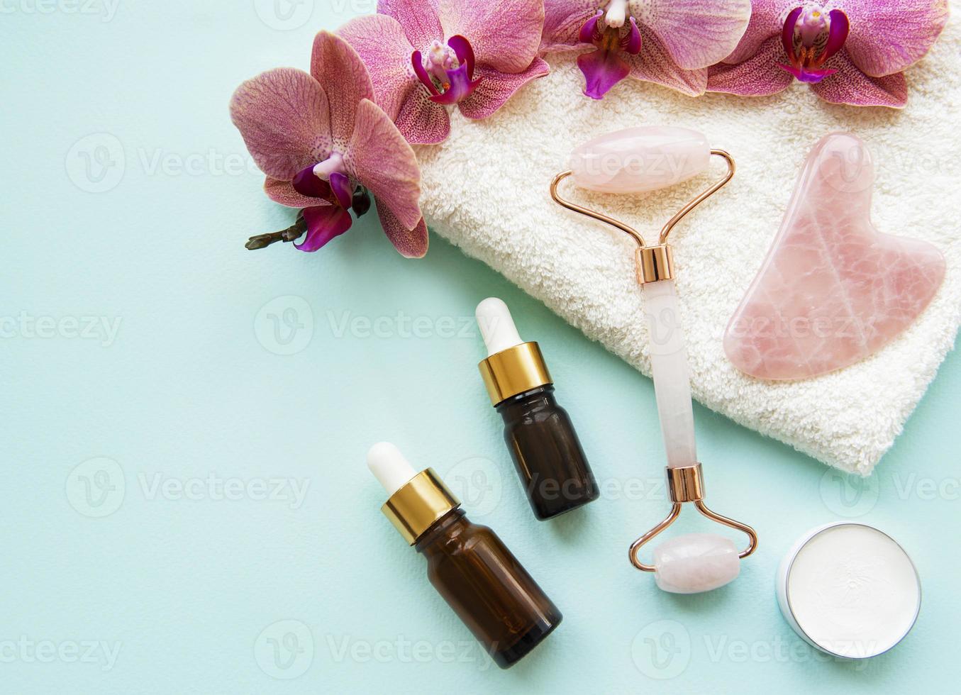 Face massage jade roller  on pastel green background photo