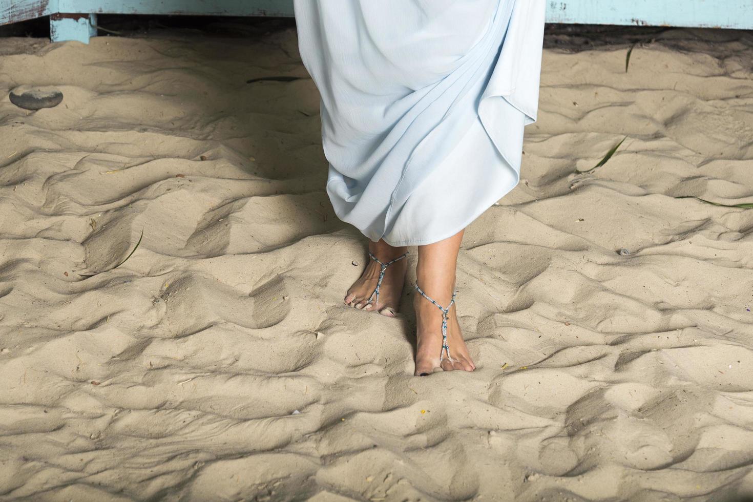 Women's feet in the sand. photo