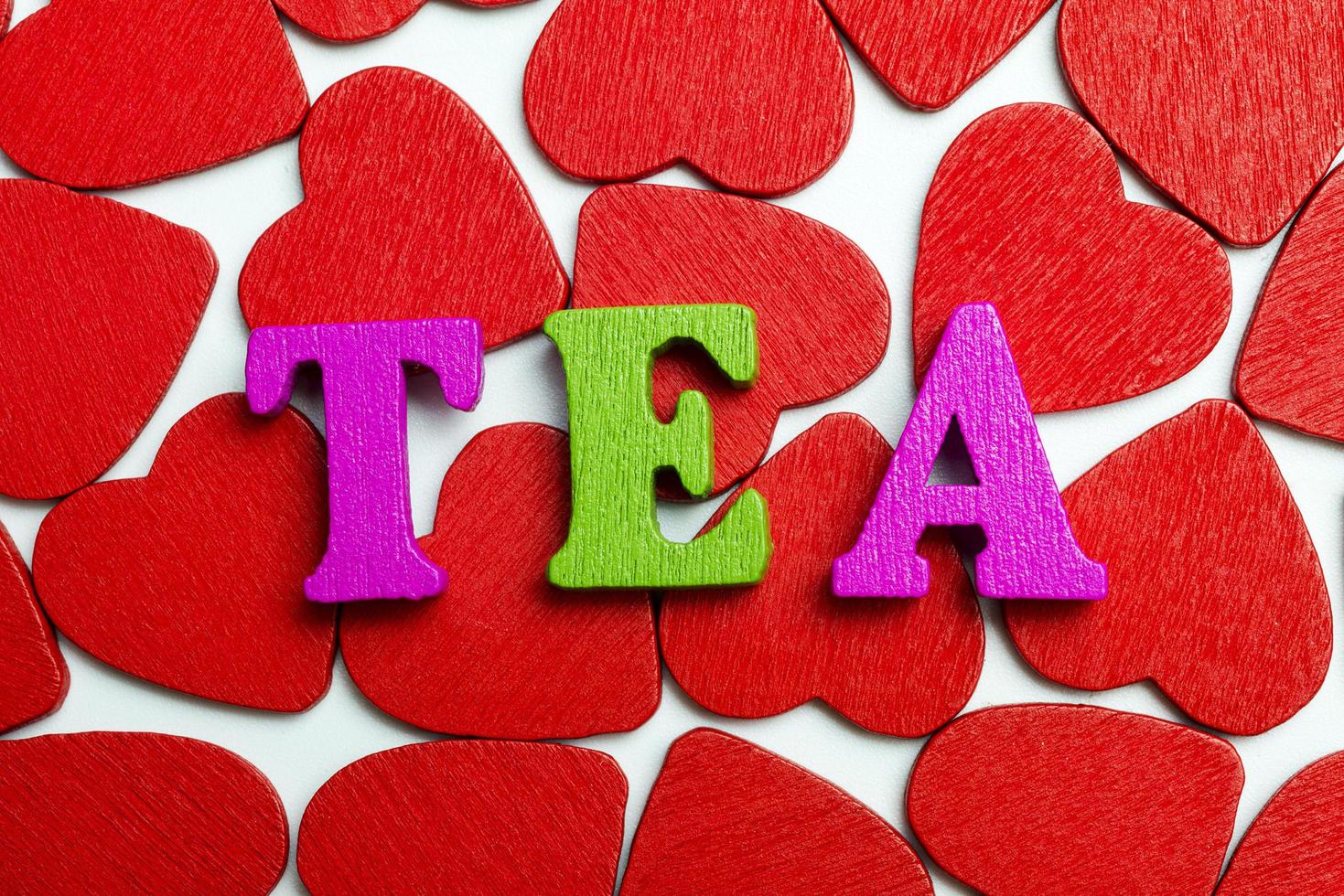 The word tea is laid out on the hearts. photo