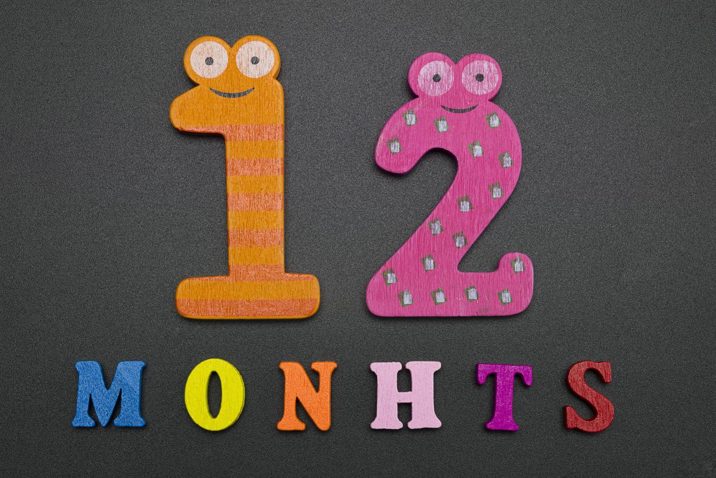 Twelve months on black background. photo