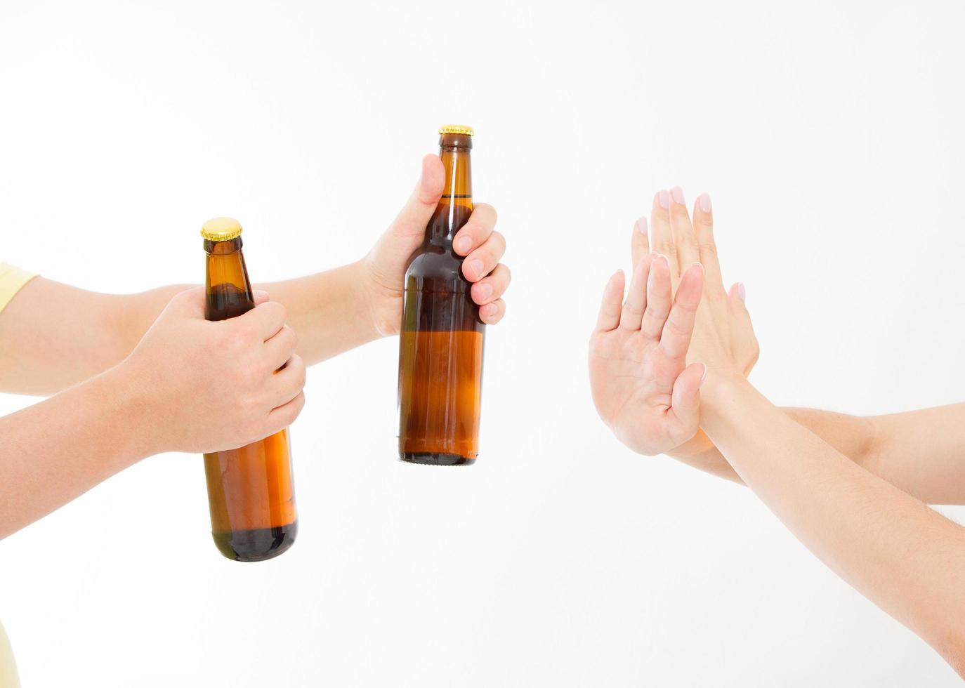 female hand reject a bottle of beer isolated on white background.anti alcohol concept. Copy space photo