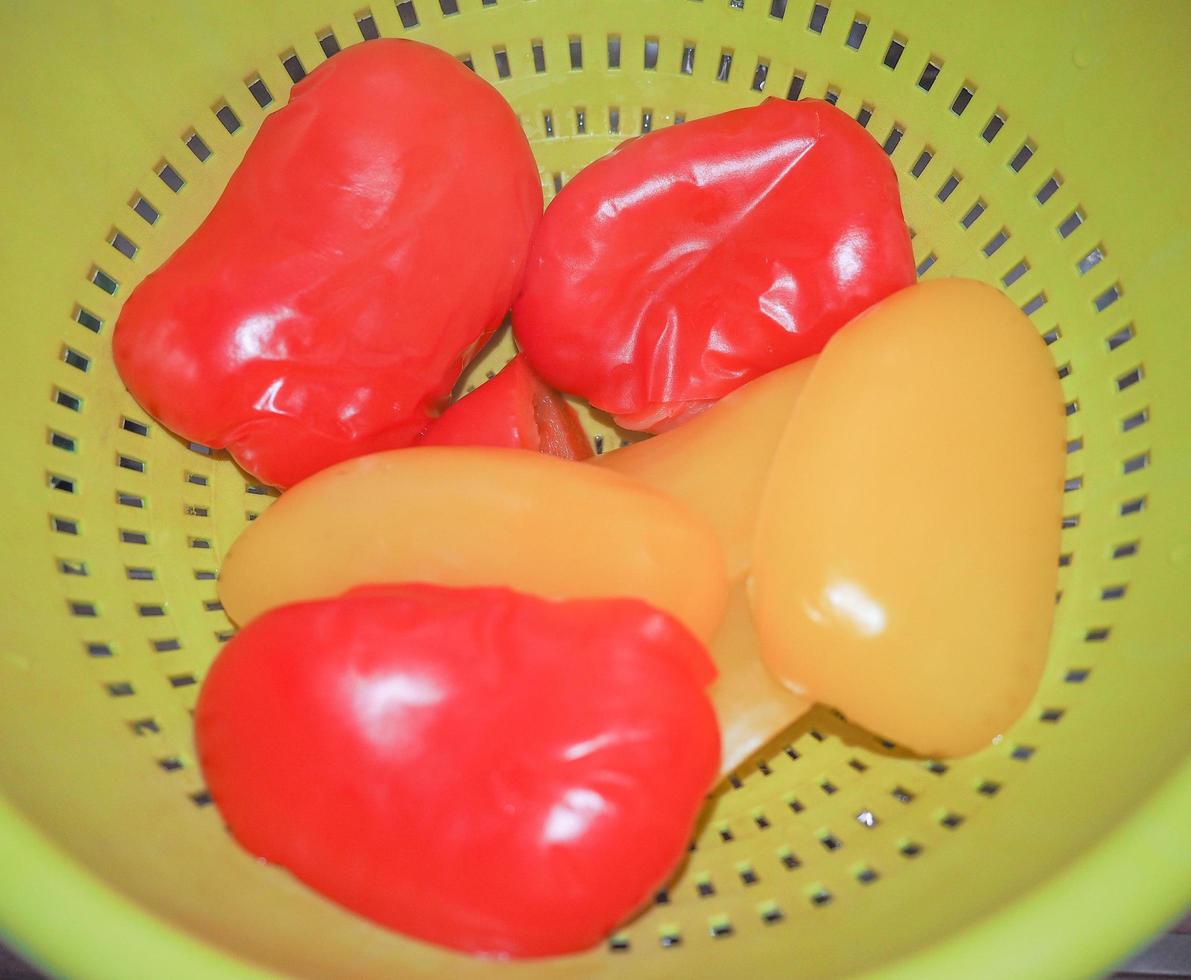 red and yellow peppers in colander photo