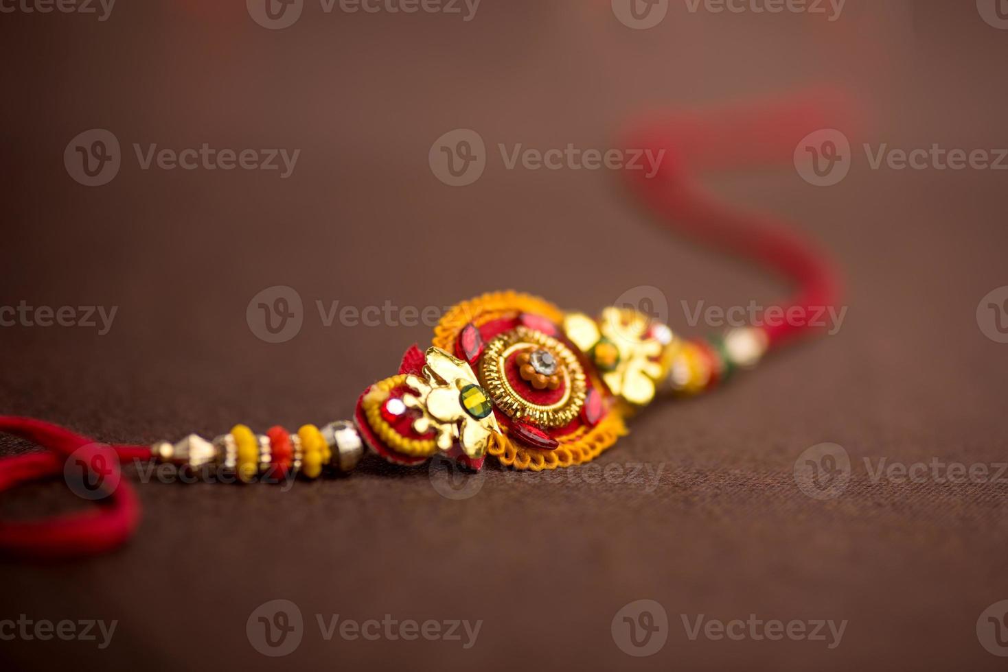 Raksha Bandhan background with an elegant Rakhi. A traditional Indian wrist band which is a symbol of love between Brothers and Sisters. photo