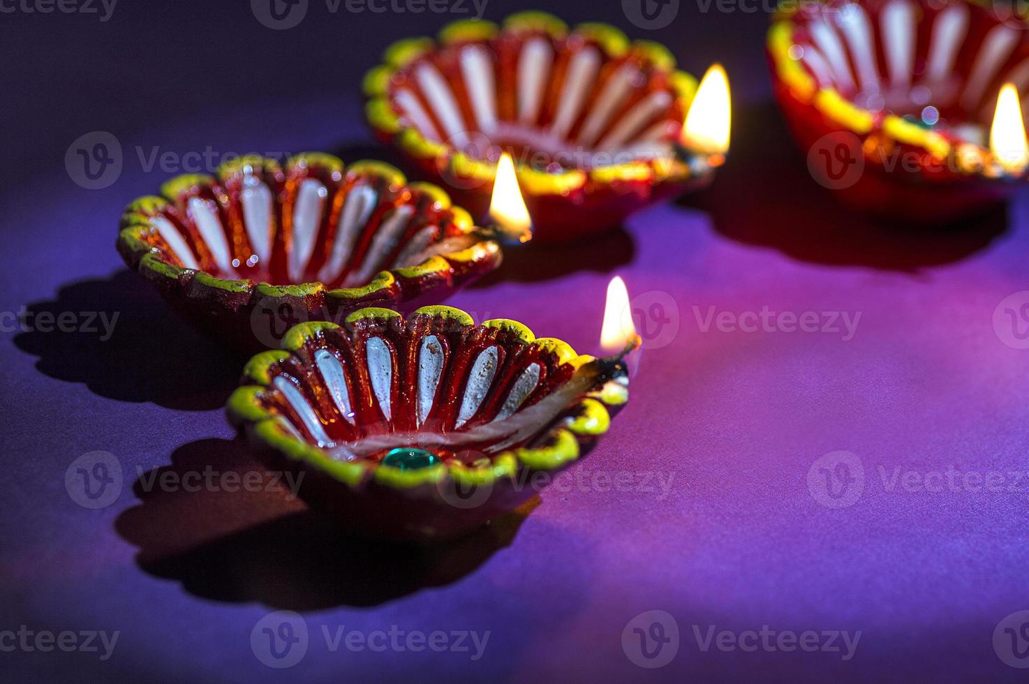 Clay diya lamps lit during Diwali Celebration. Greetings Card Design Indian Hindu Light Festival called Diwali photo