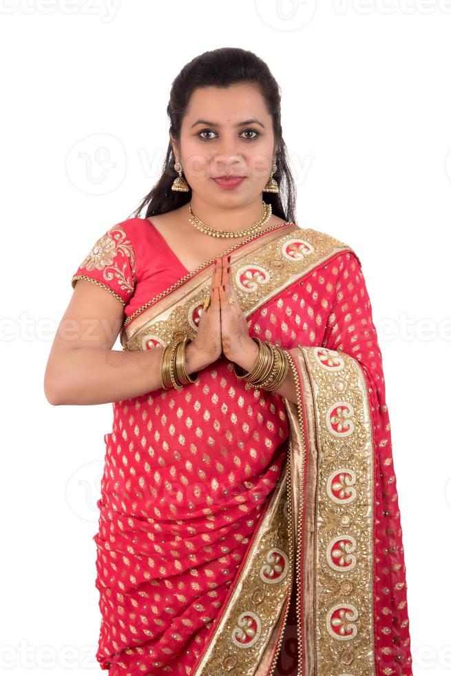 Beautiful Indian girl in a tradition sari with welcome expression inviting, greeting Namaste photo