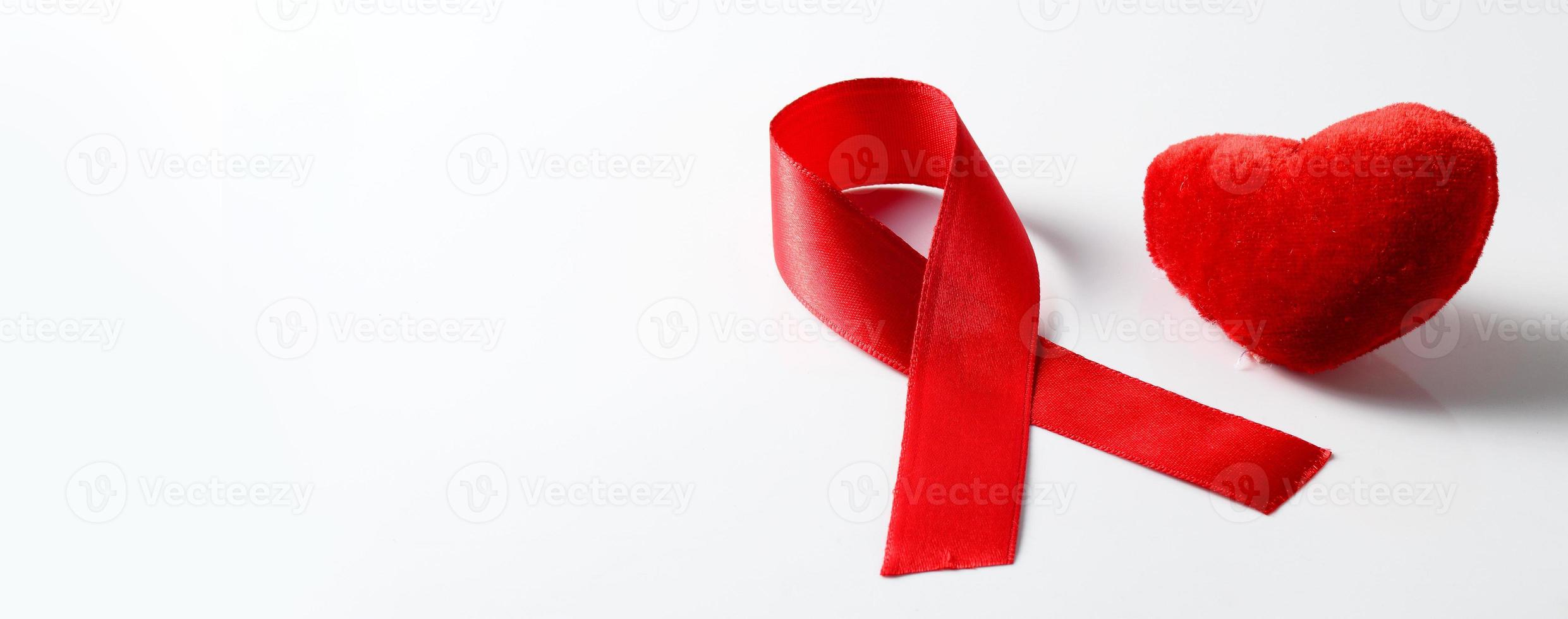 Aids ribbon and heart on white background. photo