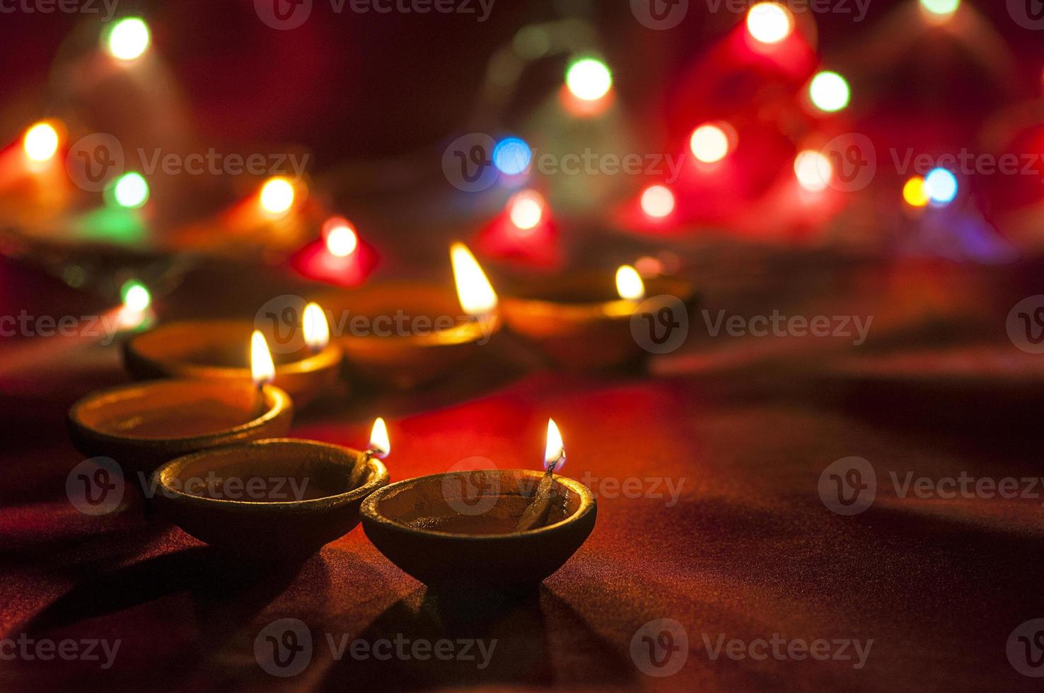 Clay diya lamps lit during Diwali Celebration. Greetings Card Design Indian Hindu Light Festival called Diwali photo