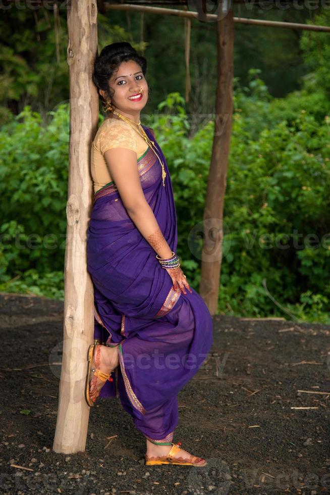 Beautiful Indian young girl in Traditional Saree posing outdoors photo