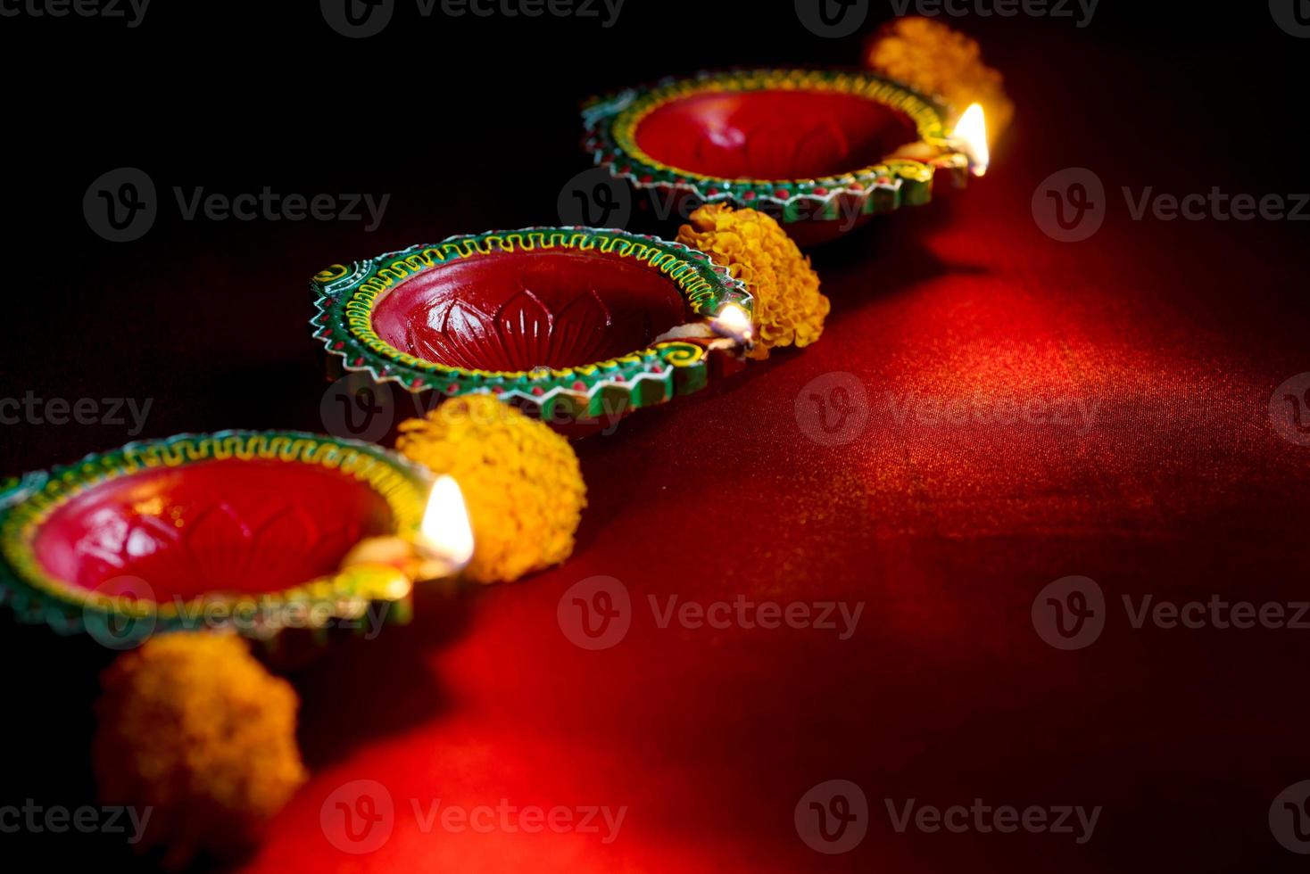 Happy Diwali - Clay Diya lamps lit during Diwali celebration. Greetings Card Design of Indian Hindu Light Festival called Diwali photo