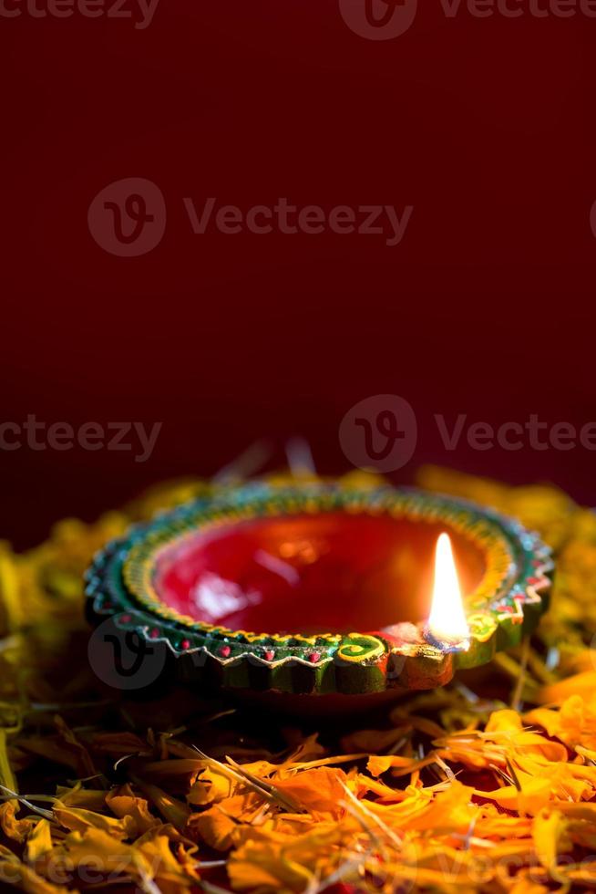 Happy Diwali - Clay Diya lamps lit during Diwali celebration. Greetings Card Design of Indian Hindu Light Festival called Diwali photo