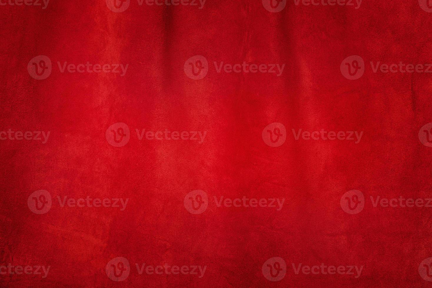 Red matte background of suede fabric, closeup. Texture of seamless leather. photo