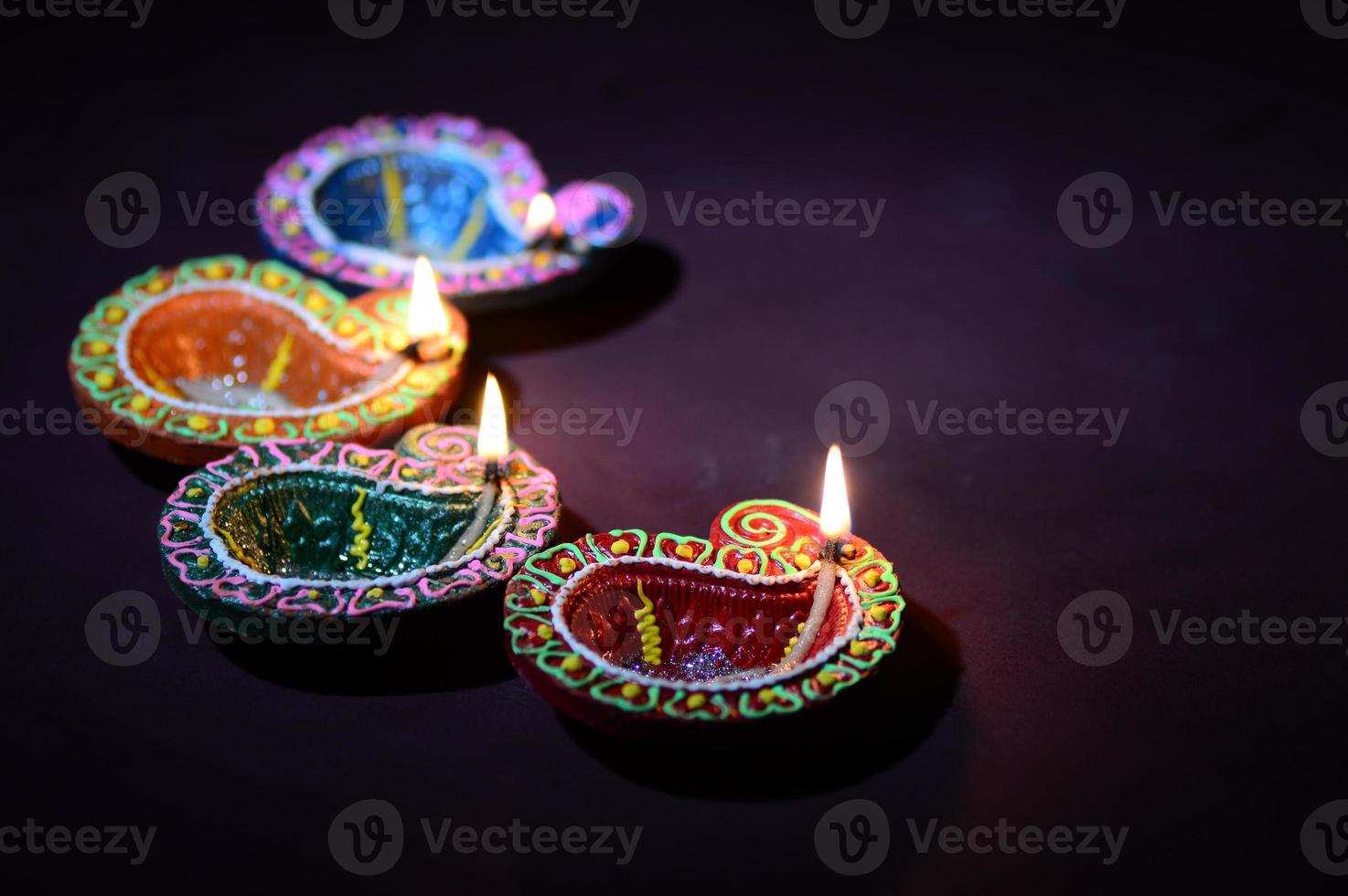 Colorful clay Diya Lantern lamps lit during Diwali celebration. Greetings Card Design Indian Hindu Light Festival called Diwali. photo